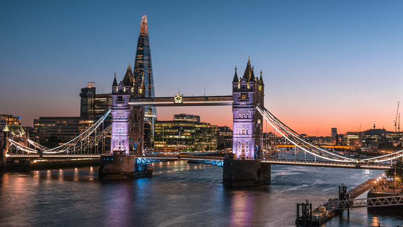 Tower Bridge illuminated over the River Thames at dusk, London